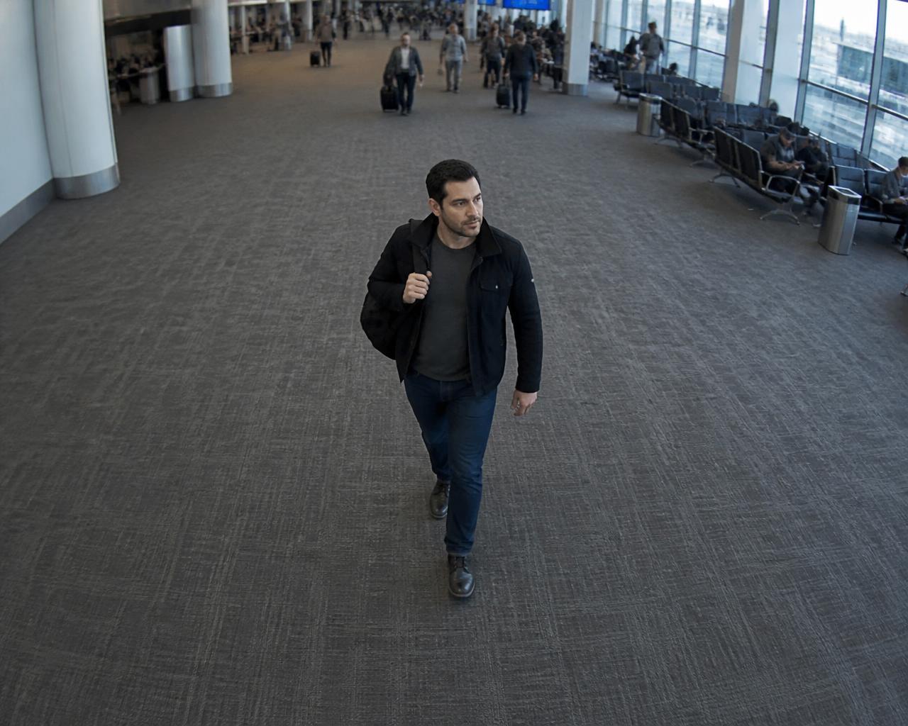 Man walking through an airport terminal recognized by Viante face recognition from an elevated security camera viewpoint